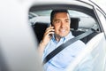 Male passenger calling on smartphone in taxi car