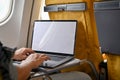 A male passenger in economy class using his portable laptop during the flight. close-up image Royalty Free Stock Photo