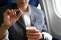 A male passenger holding a cup of water and an airsick motion sickness pills Royalty Free Stock Photo