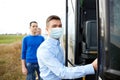 Male passenger in medical mask boarding travel bus Royalty Free Stock Photo