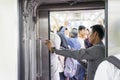 Male passenger using a mobile phone in the train