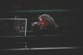 Male passenger with white hair at an old car in the dark with blur background