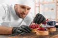 Male pastry chef preparing desserts in kitchen