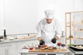 Male pastry chef preparing desserts at table