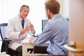 Male Patient Having Consultation With Doctor In Office Royalty Free Stock Photo