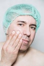 Male patient in medical cap has a severe toothache Royalty Free Stock Photo