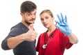 Male patient showing like and female doctor holding pill Royalty Free Stock Photo