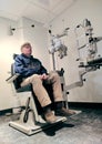 Male Patient Sitting in an Eye Doctor Exam Room