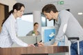 male patient talking to female receptionist Royalty Free Stock Photo