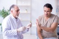 Male patient visitng doctor for shot inoculation Royalty Free Stock Photo