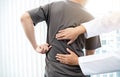 Male patients consulted physiotherapists with Low back pain for examination and treatment. Rehabilitation physiotherapy concept Royalty Free Stock Photo