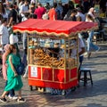 Male peddler selling simit on traditional Turkish fast food cart at Eminonu Piazza, Istanbul, Turkey