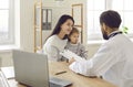 Male pediatrician examining baby and filling form at consultation Royalty Free Stock Photo