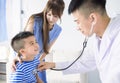 Male pediatrician hold stethoscope exam child boy patient visit doctor with mother