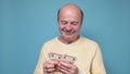 Male pensioner counting money isolated on white background Royalty Free Stock Photo