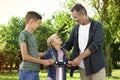 Male pensioner with grandchildren in park