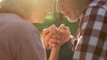 Male pensioner tenderly holding female hand on romantic date in park, closeup