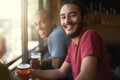 Male people, beer and chill at pub, smile and relax indoor for fun and bonding in summer to destress. Friends, bar and Royalty Free Stock Photo