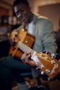 Male performer with guitar, recording studio