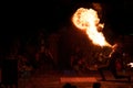 Male performer performing a captivating fire show in the dark