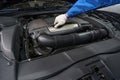 Male performing car maintenance at service station Royalty Free Stock Photo