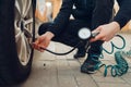 Male person checks the tire pressure, tyre service