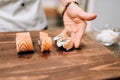 Male person cooking sushi, japanese kitchen