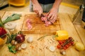 Male person cuts raw meat into slices, top view Royalty Free Stock Photo