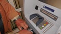 Cash machine, cash dispenser, automatic teller. Male person draws money from the ATM