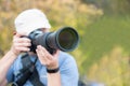 Male person with long telephoto lens