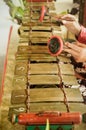 Male person playing Javanese traditional musical instrument : Gamelan