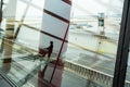 Male person silhouette reflecting in Airport terminal window.