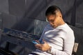 Male person sitting on a bench looking at his mobile phone Royalty Free Stock Photo