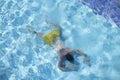 Male person in swimming pool floating on water on belly, diving on depth Royalty Free Stock Photo