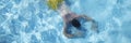 Male person in swimming pool floating on water on belly, diving on depth Royalty Free Stock Photo