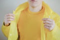 Male person in yellow t-shirt and raincoat. Royalty Free Stock Photo