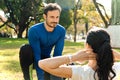 Male personal trainer training a woman outdoors Royalty Free Stock Photo