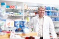 Male pharmacist at drugstore. Portrait of mature male pharmacist smiling at drugstore. Royalty Free Stock Photo