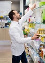 Male pharmacist looking for right medicine Royalty Free Stock Photo