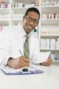 Male Pharmacist Working In Pharmacy