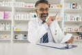 Male Pharmacist Working In Pharmacy