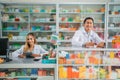 male pharmacist writing and female pharmacist holding pad working Royalty Free Stock Photo