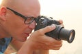 Male photographer close-up. The photographer looks into the lens