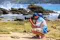 Male photographer with DSLR camera on the beach Royalty Free Stock Photo