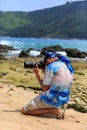 Male photographer with DSLR camera on the beach Royalty Free Stock Photo