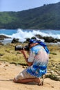 Male photographer with DSLR camera on the beach Royalty Free Stock Photo