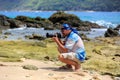 Male photographer with DSLR camera on the beach Royalty Free Stock Photo