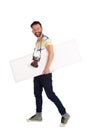 Male photographer with empty sigh board walking over white background Royalty Free Stock Photo