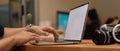 Male photographer hands typing on mock up laptop in studio