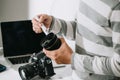 Male photographer holding digital camera above the desk in his photo studio Royalty Free Stock Photo